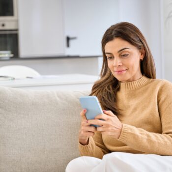 e-Sănătatea Mea: ce poți face acum în platformă și cum îți creezi cont Relaxed,Middle,Aged,Older,Woman,Using,Smartphone,Sitting,On,Couch